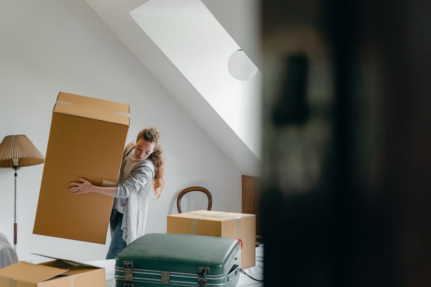 Person carrying boxes during a home cleanout